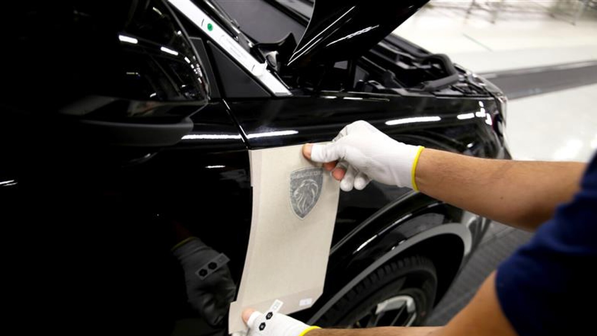 Onderhoudstechnieker werkt aan een Peugeot wagen